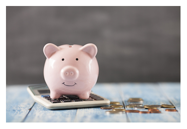 Piggy bank sitting on calculator